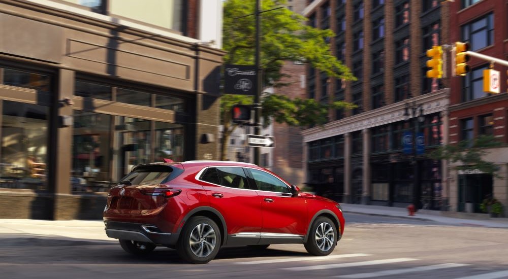 Red 2023 Buick Envision driving to a Buick dealer near Port Huron