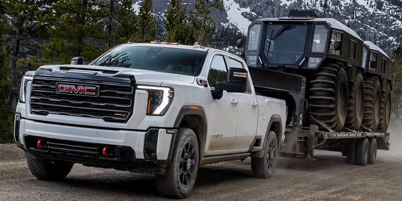 2026 GMC Sierra 2500 HD SLT towing heavy trailer off-road