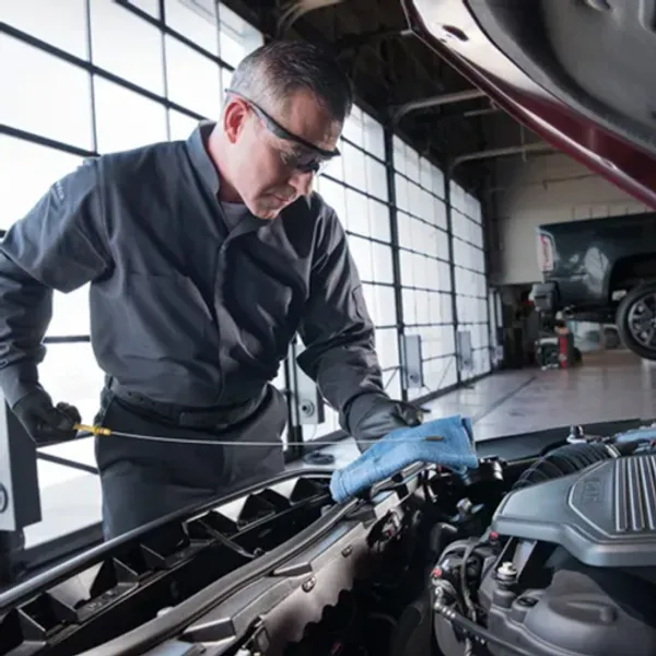 image of a man checking oil