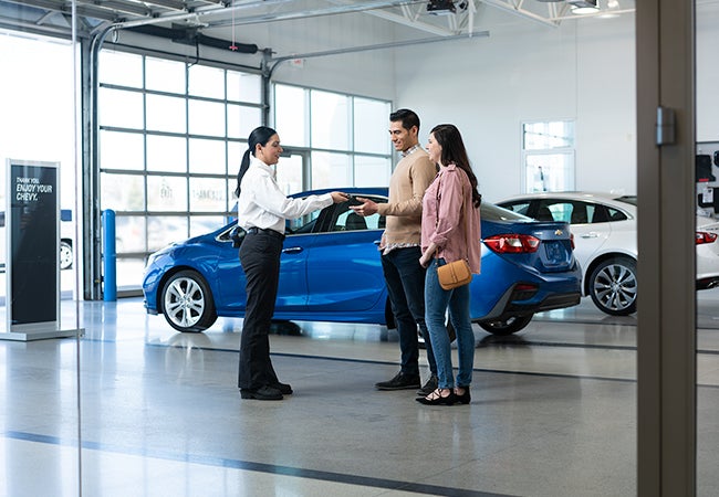 A service advisor and customers at a service center.