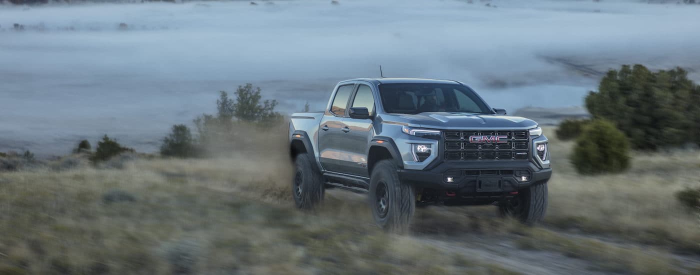 A silver 2024 GMC Canyon AT4X AEV driving to a GMC dealer near Port Huron.