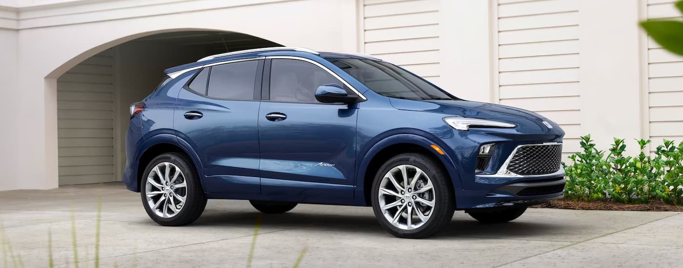 A blue 2024 Buick Encore GX is parked on a driveway.