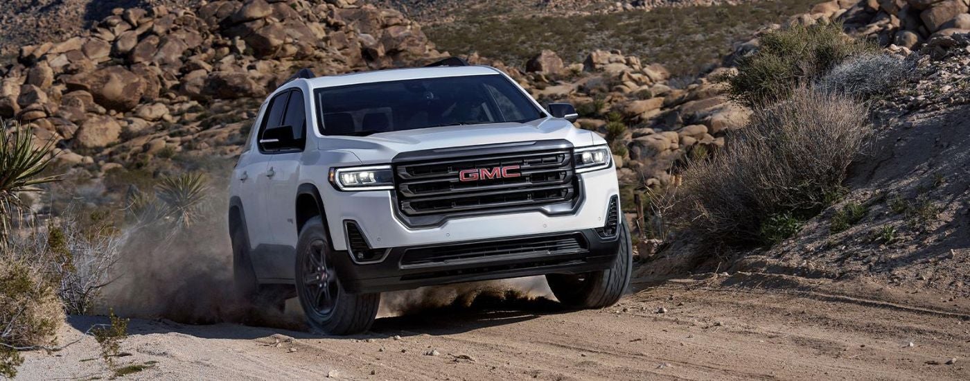 White used 2022 GMC Acadia for sale driving off-road.