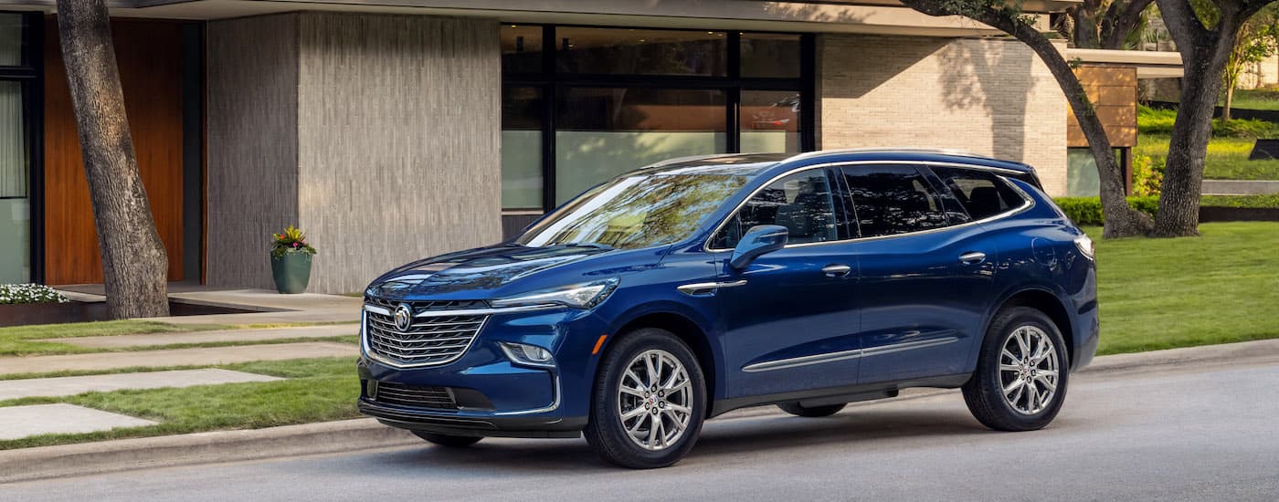 A blue 2024 Buick Enclave from the side after leaving a used Buick dealer near Clinton Township.